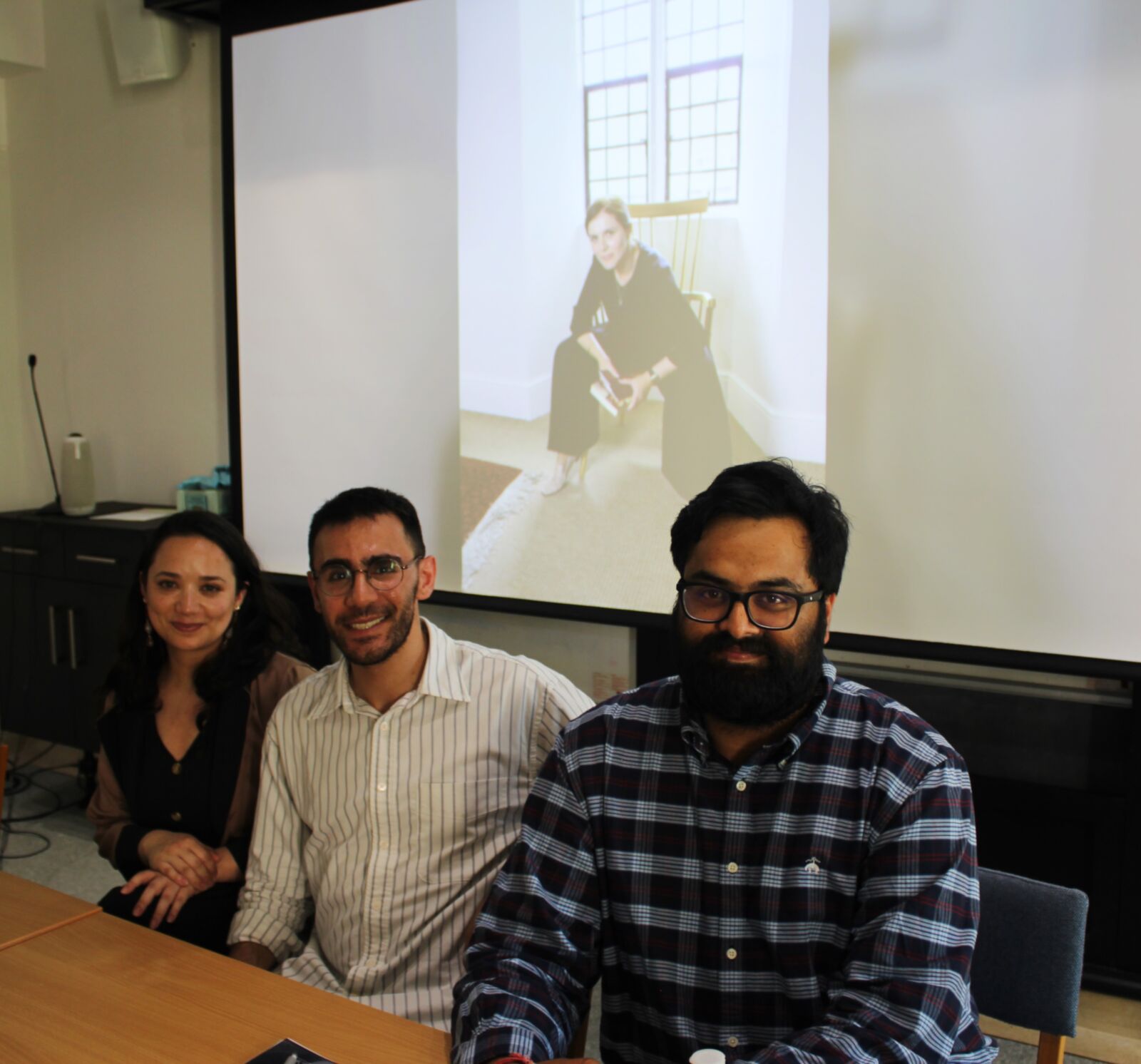 A presenter with academic and student commentators